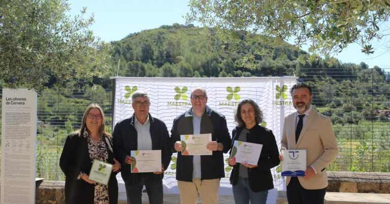 Group of five adults posing outdoors, each holding a certificate, in front of a white banner with green logos and a hillside backdrop.