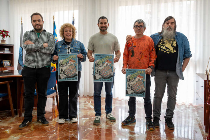 Five adults stand in a bright room, four men and one woman, each holding a colorful poster facing the camera.